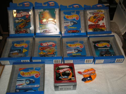 1990 Ford Bronco - Several Hot Wheels toy cars are displayed in their original packaging, some special anniversary editions.
