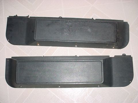 1983 Ford Bronco - Pair of black plastic interior door panels shown from the front.