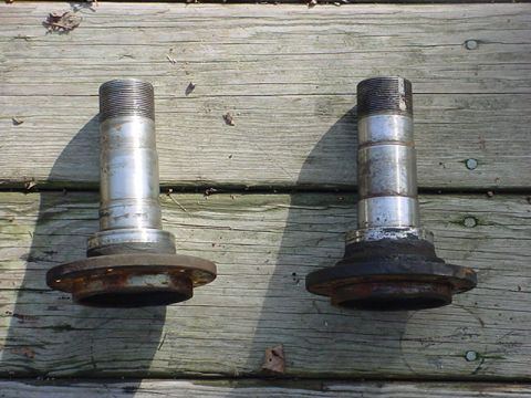1983 Ford Bronco - Two front wheel hubs are shown side-by-side on a weathered wooden deck.