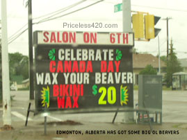 1989 Ford Bronco - A digital billboard displays advertisements for a salon and Canada Day services, including a bikini wax special.