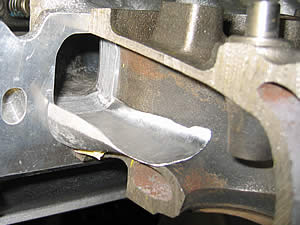 1972 Ford Ranchero - Close-up view of an engine intake manifold port, showing metal modification. SUPERMOTORS.NET logo visible.