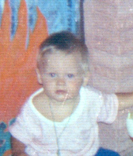 1989 Ford Bronco - A baby is pictured in front of a colorful background with a watermark at the bottom right.