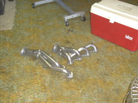 1978 Ford Bronco - A pair of exhaust headers are shown on the floor, with a cooler and stand nearby.
