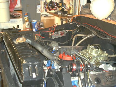1978 Ford Bronco - The engine bay of a 1978 Ford Bronco shows a V8 engine with a carburetor and radiator.