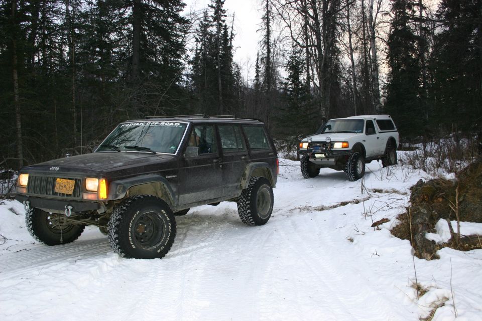 Dark 2003 Jeep Cherokee XJ in snow with "KODIAK OFF-ROAD" sticker