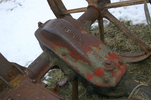 2003 Jeep TJ - A close-up view of a weathered McCormick-Deering component, indicating its agricultural machinery origin.