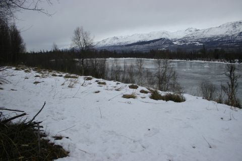 2003 Jeep TJ - A winter scene depicts a frozen river and snow-covered landscape with mountains in the background.
