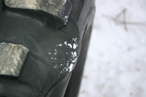 2003 Jeep TJ - A close-up view of a tire's tread shows white debris scattered across the dark rubber.