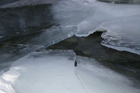 2003 Jeep TJ - Cracked ice covers dark water, suggesting a frozen river or lake.