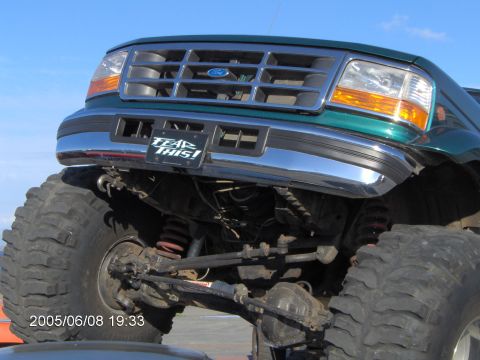 1996 Ford Bronco - This modified 1992 Ford Bronco features oversized tires and a lifted suspension, with a "TEAR THIS!" sticker on the bumper.