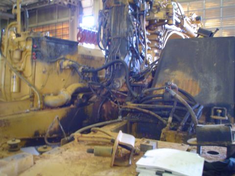 1966 International School Bus - The engine compartment of a large piece of machinery, showing intricate hydraulic and electrical systems.