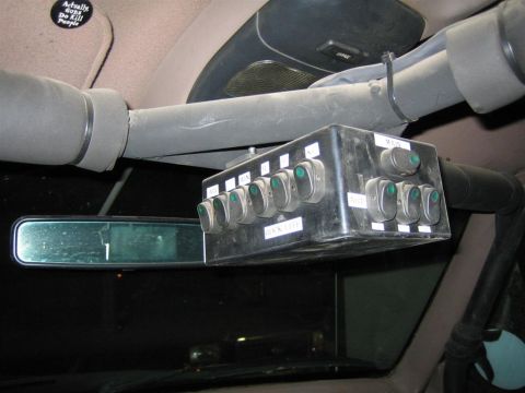 1994 Ford Bronco - A custom switch box is mounted inside the vehicle's cabin, multiple labeled toggle switches.