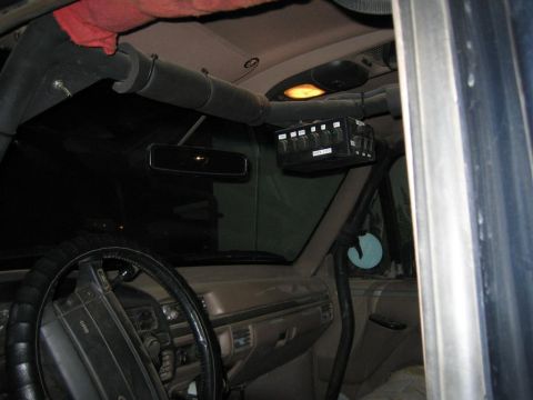 1994 Ford Bronco - Vehicle interior with a custom overhead switch panel and roll cage components.