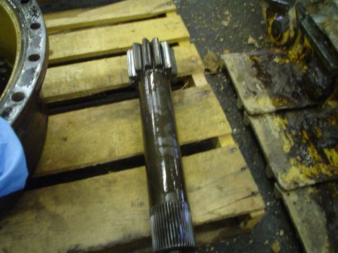 1966 International School Bus - A close-up view of a metal shaft with gear teeth, likely a component from heavy machinery.