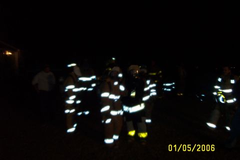 1998 Ford Crown Victoria - Firefighters are seen in their reflective gear at night, with the date 01/05/2006 visible in the lower right corner.
