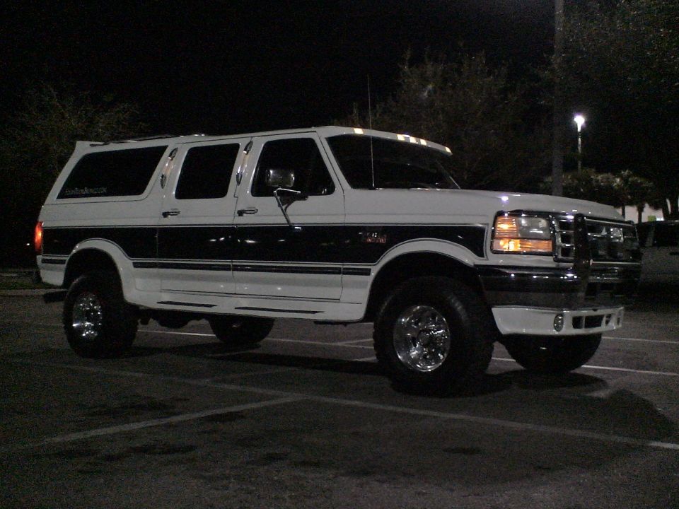 White Ford Bronco Centurion SUV with dark stripe, lifted on chrome wheels