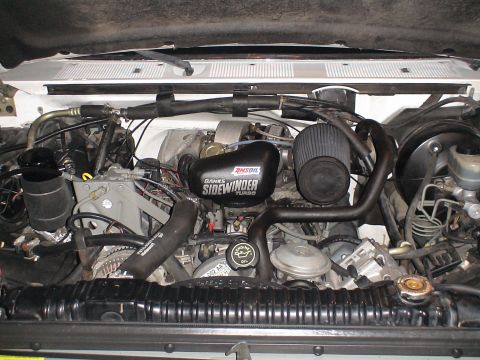 1993 Ford C-350 (Centurion Conversions) - The engine bay features a Banks Sidewinder turbocharger and AMSOIL air filter, with numerous hoses and mechanical parts visible.