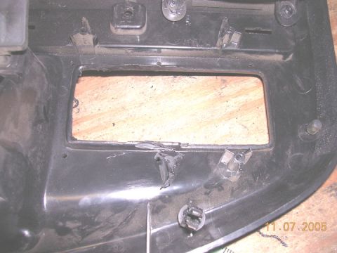 1994 Ford Bronco - A close-up view of a damaged black plastic dashboard switch panel with a rectangular opening.