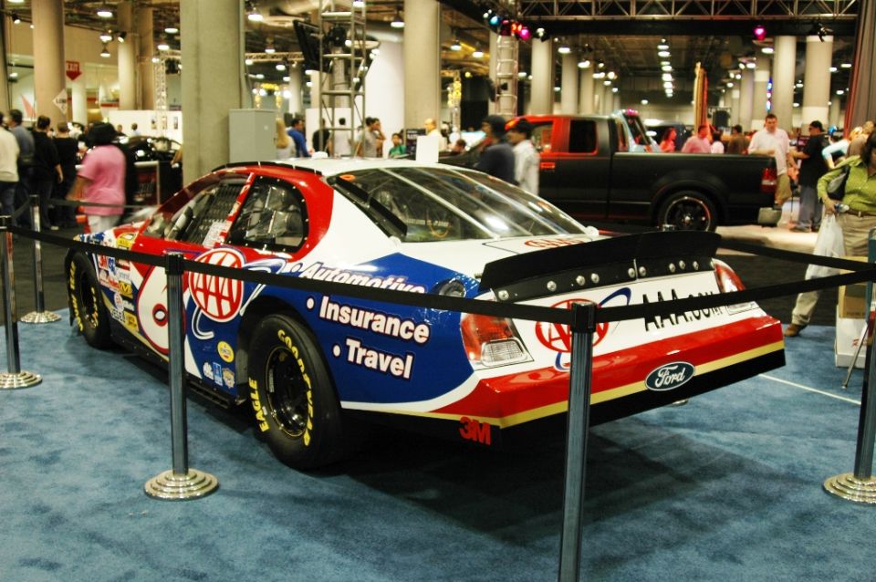 Race car with AAA Insurance and Travel livery, rear view, black spoiler, Ford logo on rear bumper