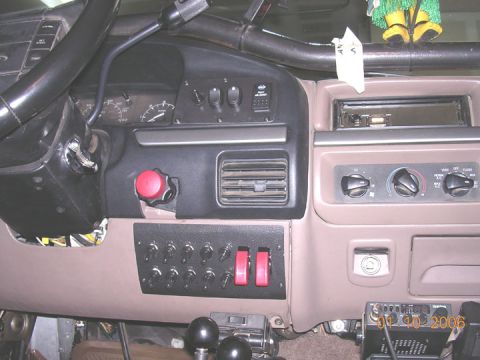 1994 Ford Bronco - The interior of a vehicle shows a custom switch panel installed on the dashboard.