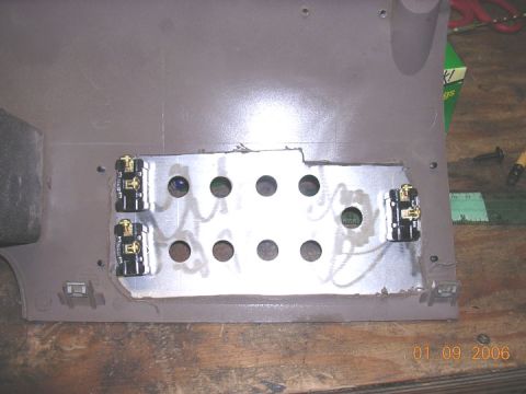 1994 Ford Bronco - A custom-made switch panel with multiple circular openings and four installed toggle switches is shown.