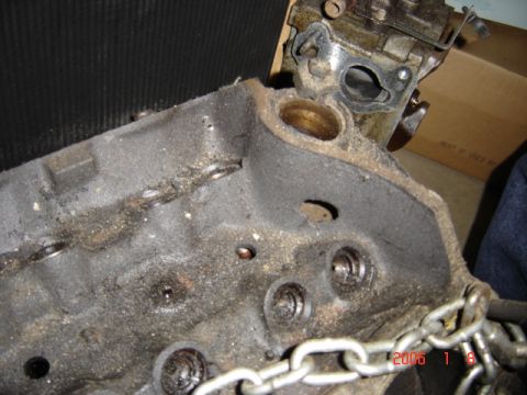 1990 Ford Bronco - Close-up of a greasy engine block, indicating it is a part of a larger vehicle.