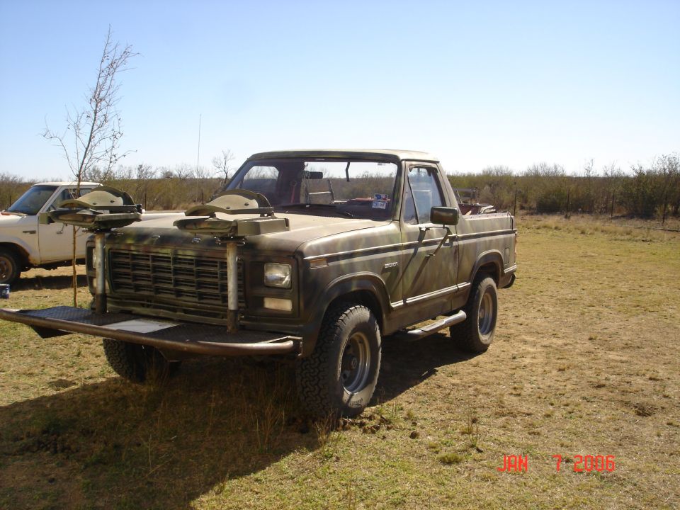 Camouflaged pickup truck with custom bumper and hood accessories
