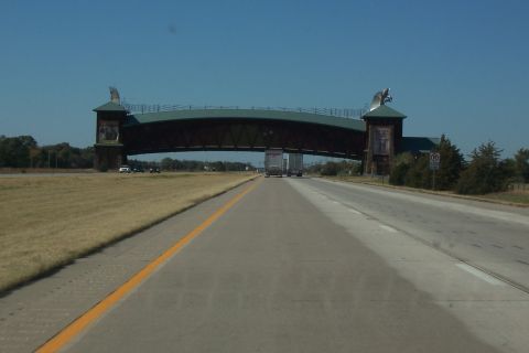 1998 Mercury Sable - Driving under a distinctive bridge structure on a clear day.