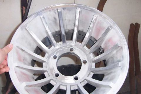 1976 Jeep CJ7 - Close-up of an aluminum alloy wheel, possibly undergoing restoration or modification.