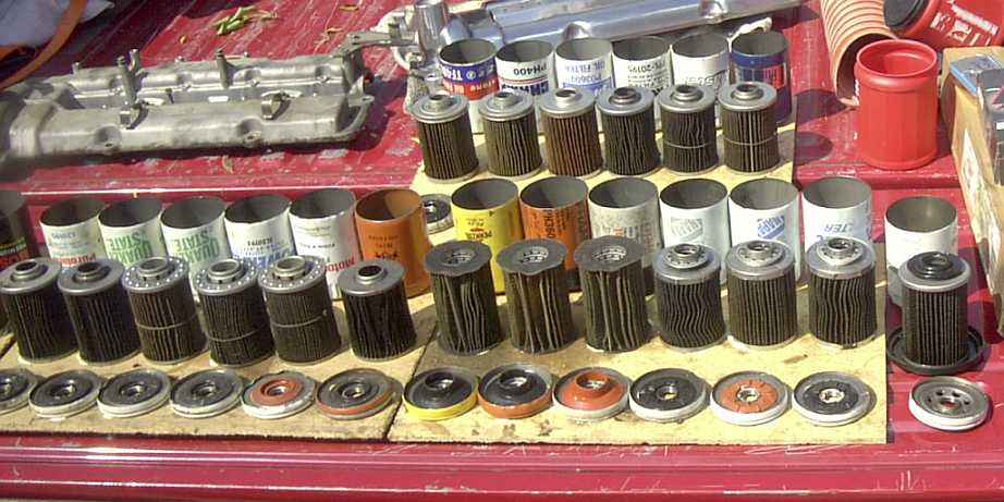 Collection of oil filters and gaskets on a red surface