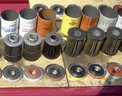 1997 Ford Taurus - A collection of various oil filters and their associated gaskets are displayed, some with visible brand names.