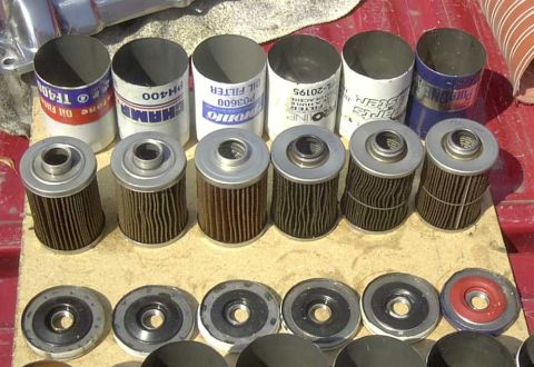 1997 Ford Taurus - A collection of oil filters and their corresponding gaskets are laid out for display.