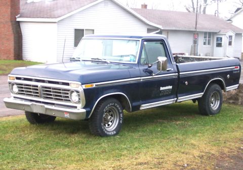 1975 Ford F-150 - This 1975 Ford F-150 pickup truck is seen from a three-quarter front angle, parked on a grassy lawn.