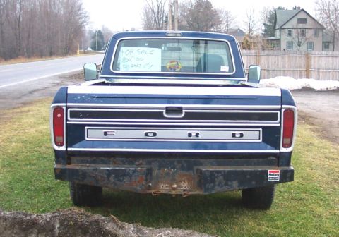 1975 Ford F-150 - This 1975 Ford F-150 pickup truck is seen from the rear, with a 'For Sale' sign displayed in the back window.
