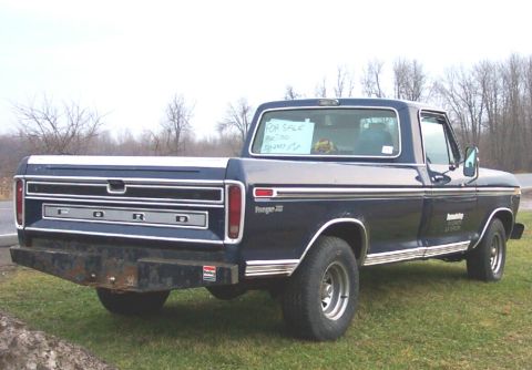 1975 Ford F-150 - This 1975 Ford F-150 pickup truck is shown from the rear with a 'For Sale' sign in the window.