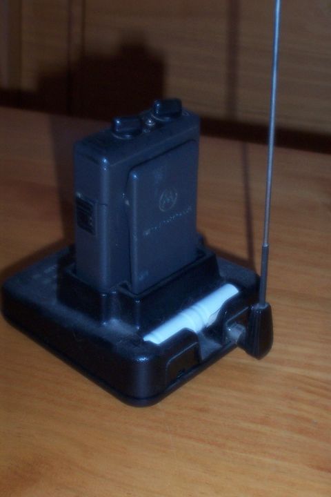 1998 Ford Crown Victoria - Motorola pager and charging base on a wooden surface.
