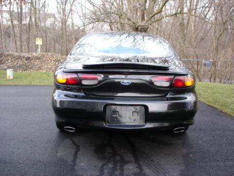 1998 Ford Taurus - Rear view of a black 1998 Ford Taurus showing its taillights, spoiler, and dual exhaust.