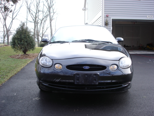 black Ford Taurus parked in driveway