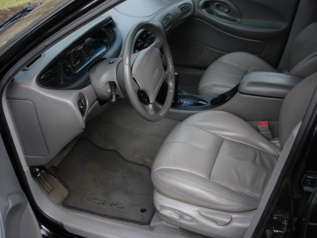 Gray leather interior of a 1998 Ford Taurus SHO, showing dashboard, steering wheel, and seats