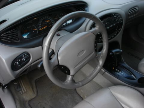 1998 Ford Taurus - Interior view of a 1998 Ford Taurus, its dashboard, steering wheel, and automatic transmission shifter.