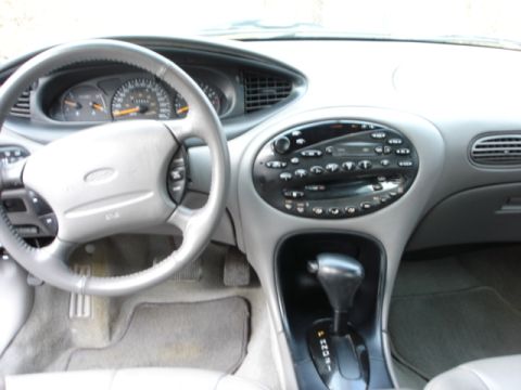 1998 Ford Taurus - The interior of a 1998 Ford Taurus is visible, with a focus on the dashboard and controls.