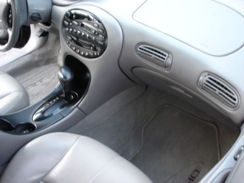 1998 Ford Taurus - Interior console of a car with automatic shifter, gray leather seats, dash vents and SHO-style center stack.
