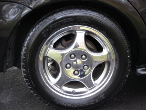 1998 Ford Taurus - Polished chrome five-spoke alloy wheel mounted on a BFGoodrich g-Force T/A KDW tire on a dark vehicle.