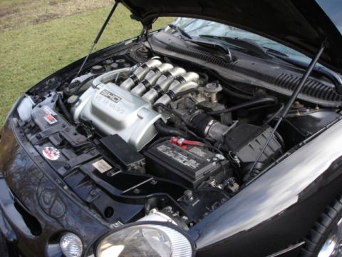 1998 Ford Taurus - The V8 32 Valve SHO engine is visible in the engine bay of this black 1998 Ford Taurus.