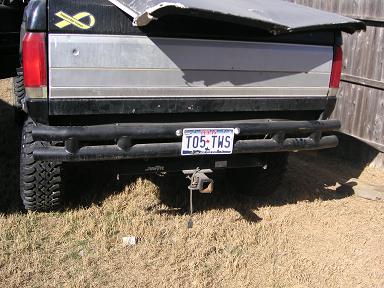 1990 Ford Bronco - The rear of a Ford Bronco is shown, a custom bumper and a license plate.