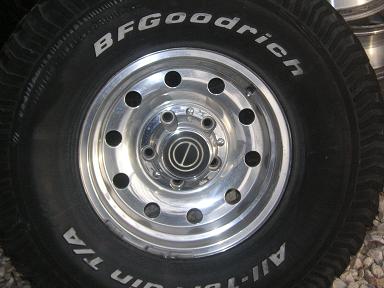 1990 Ford Bronco - Close-up of a BFGoodrich All-Terrain T/A tire mounted on a shiny chrome wheel.