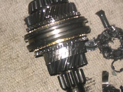 1996 Ford Probe - Close-up of severely damaged transmission gears, showing metal fragments and a fractured component.