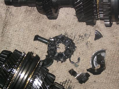 1996 Ford Probe - Transmission gears are heavily damaged, with significant breakage and metal debris visible.