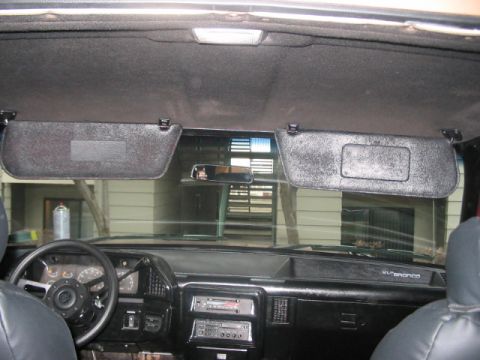 1991 Ford Bronco - Interior view of a 1991 Ford Bronco, showing the dashboard, steering wheel, and sun visors.