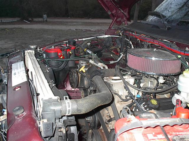 2001 Dodge 1500 engine bay with aftermarket air filter and red battery terminals